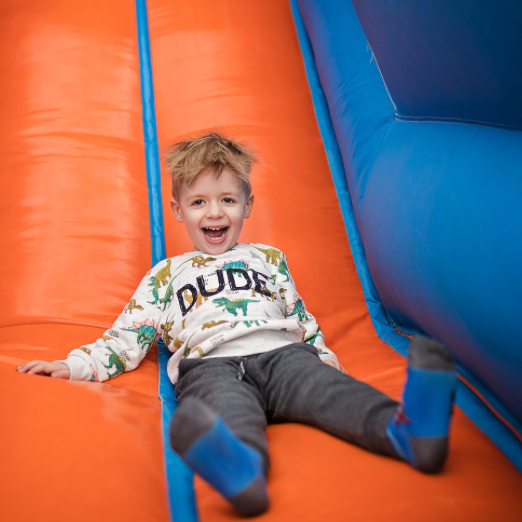 Bouncy House Rentals Orange and Blue Kids Having Fun